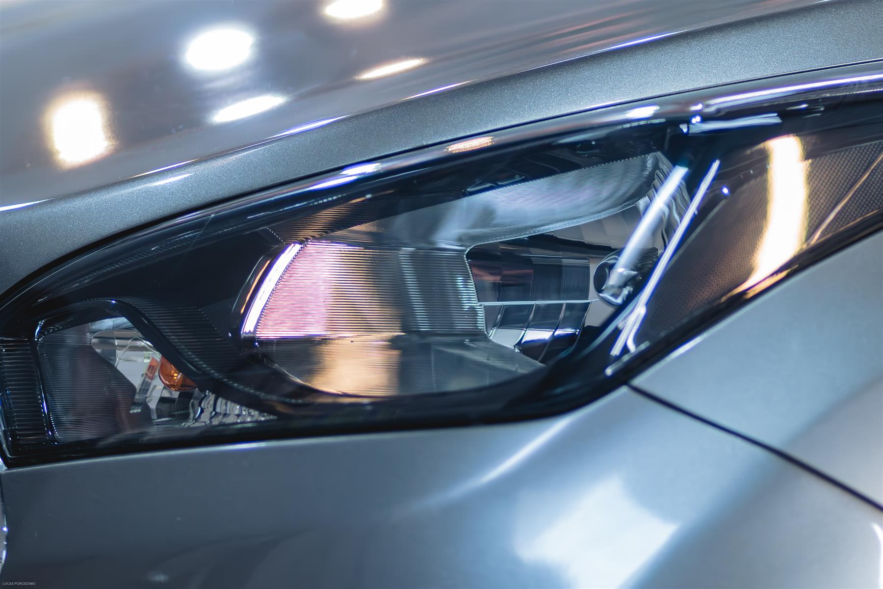 Detalhe do farol e da pintura de um carro no estúdio Maninho Deluxe